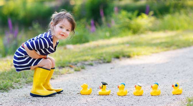 Girl looking at rubber duck representing how to pick a homeschool curriculum